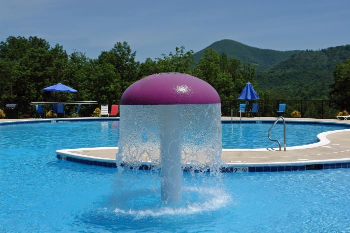 The pool's mushroom splash fountain with mountains in the distance